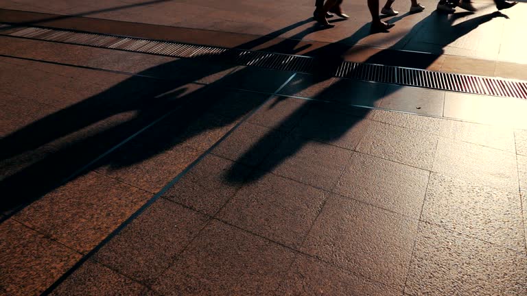 HD Slow motion: Silhouettes of Pedestrians Commuting in City.