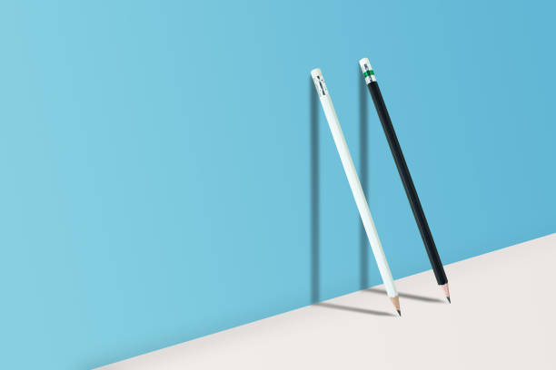 istock Business Creative and Idea Concept : Black and White pencils standing on white floor and shadow on blue wall. 1135447390