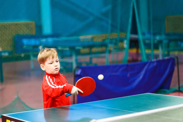 child plays table tennis in the gym, sport