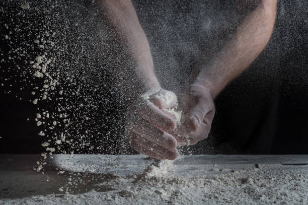 istock Man prepares a meal of flour 1135452534