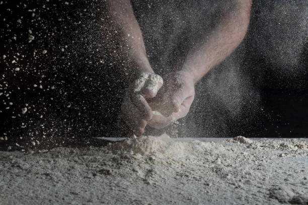istock Man prepares a meal of flour 1135452538