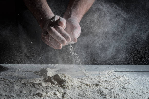 istock Man prepares a meal of flour 1135452603