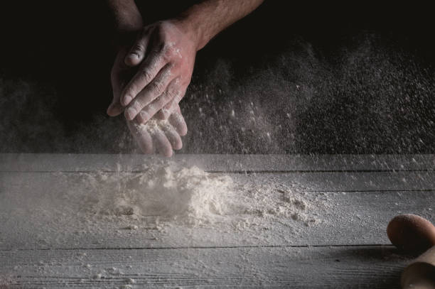 istock Man prepares a meal of flour 1135452623