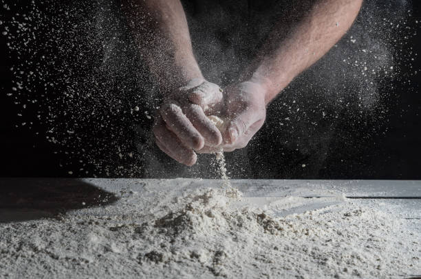 istock Man prepares a meal of flour 1135452628