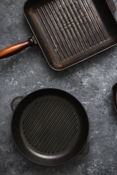 istock Set old grill pans dark stone background top view 1135456569