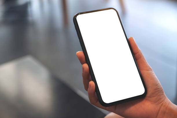 istock Mockup image of woman's hands holding black mobile phone with blank white screen in cafe 1135456786