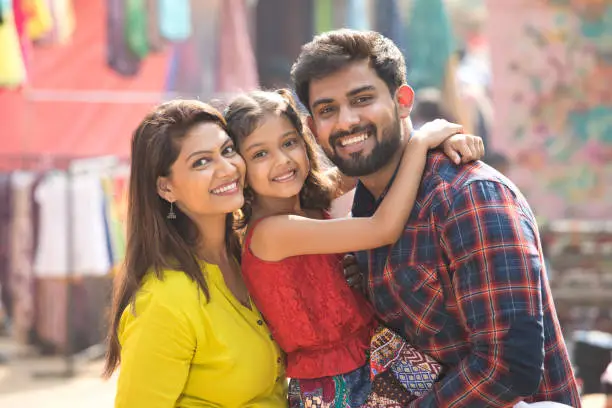 Happy Indian family at street market