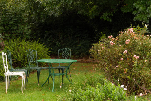 istock Table and chairs in a beautiful garden setting. 1135459033