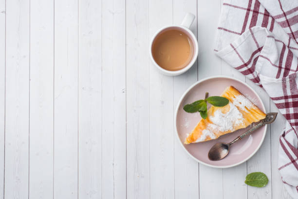 istock Cottage cheese casserole on a plate with powdered sugar and mint leaves. Selective focus Copy space 1135463795