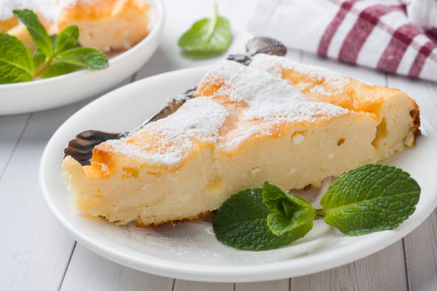 istock Cottage cheese casserole on a plate with powdered sugar and mint leaves. Selective focus 1135464463