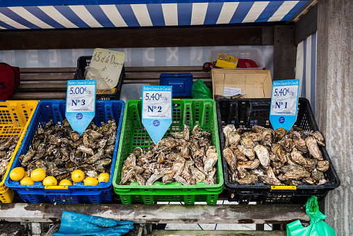 Crates with fresh oysters for sale at the french coast of Brittany