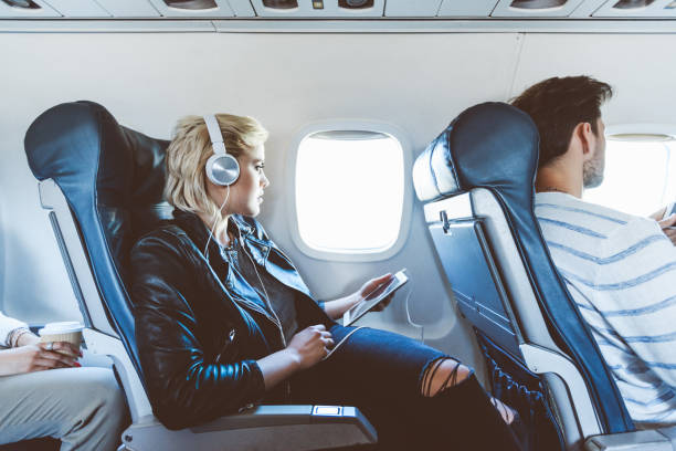 istock Woman traveling by plane with digital tablet 1135467967