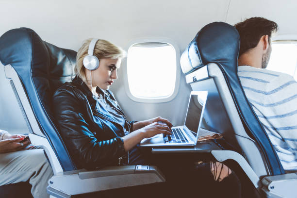istock Female traveler in a flight using laptop 1135468737