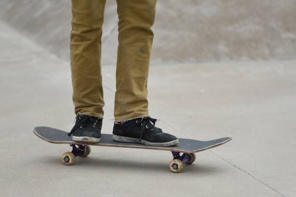 Legs on a skateboard stock photo