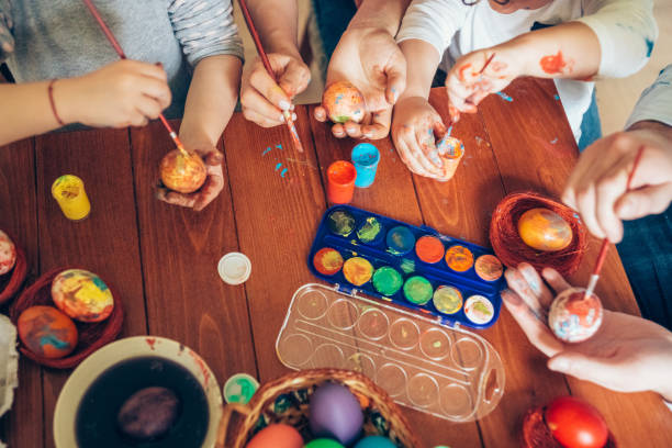istock Happy family painting Easter eggs 1135469954
