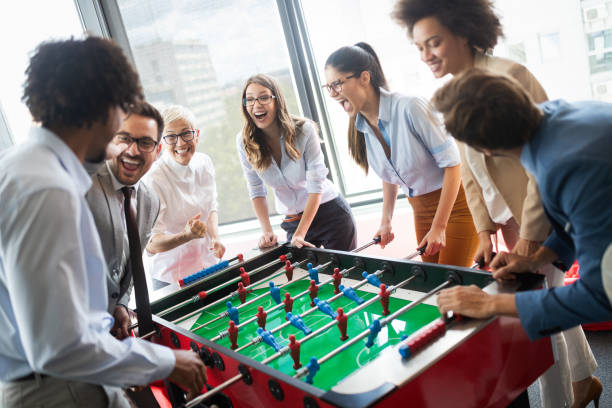 istock Colleagues playing table football in the break. 1135470247