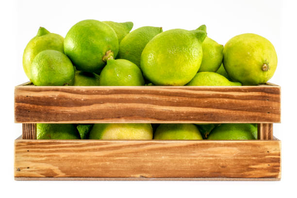istock Lemons in wooden crate isolated on white background 1135471871