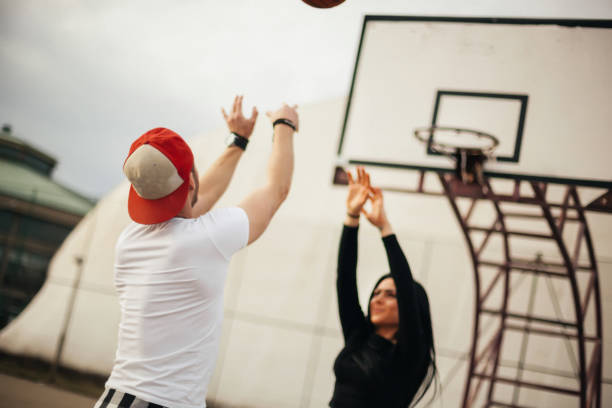 istock Couple having fun on basketball 1135474160