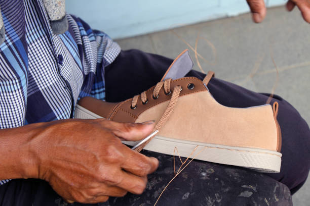 istock Process of manual shoe reparation, sole and welt fixing and stitching. 1135474870