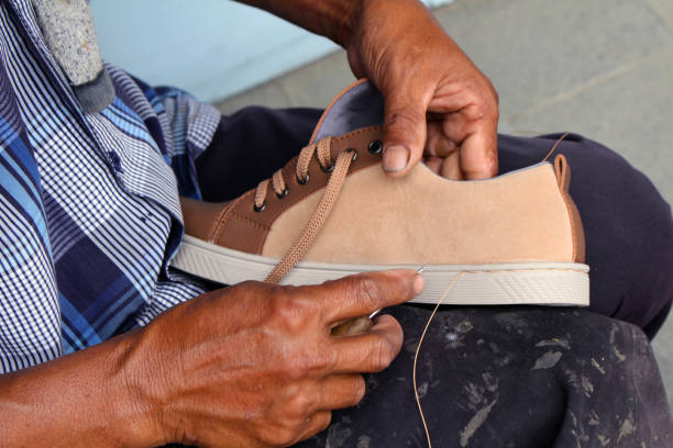 istock Process of manual shoe reparation, sole and welt fixing and stitching. 1135474926