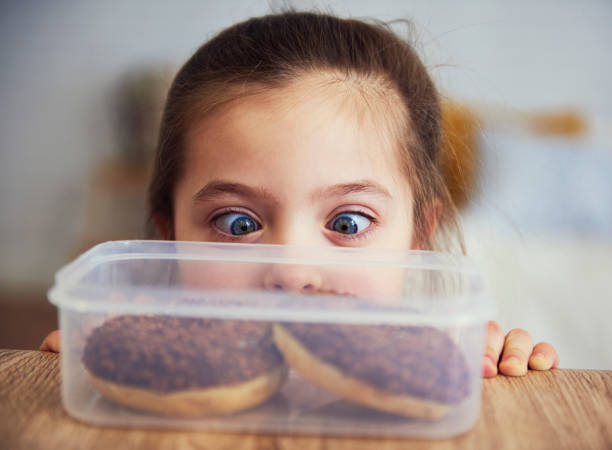 Child looking at delicious donuts Child looking at delicious donuts temptation photos stock pictures, royalty-free photos & images