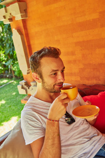 istock Man drinking coffee on a home porch. 1135475216
