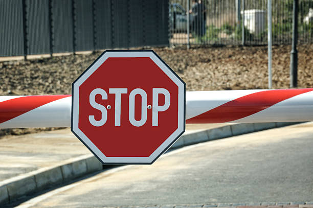 Security entry with big red Stop sign on the beam http://dl.dropbox.com/u/8883987/Signs.jpg security barrier photos stock pictures, royalty-free photos & images
