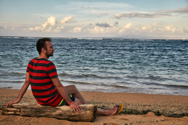 istock Man enjoying on a deserted tropical beach. 1135476811