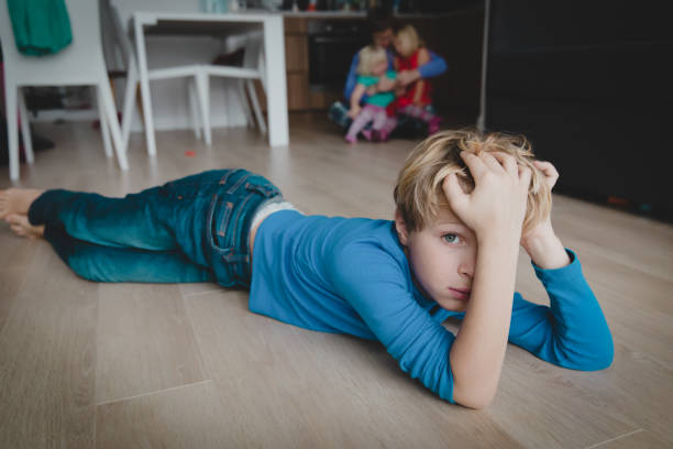 istock sad boy and father hugging other kids, siblings rivalry 1135476929