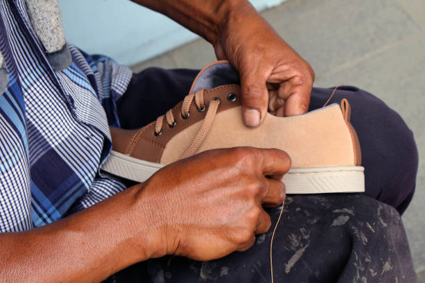 istock Process of manual shoe reparation, sole and welt fixing and stitching. 1135476961