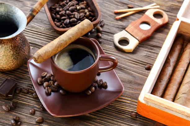 Cigars and a cup of black coffee Cigars and a cup of black coffee on a wooden table coffee cigar stock pictures, royalty-free photos & images