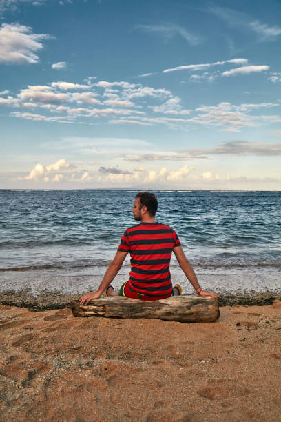 istock Man enjoying on a deserted tropical beach. 1135477835