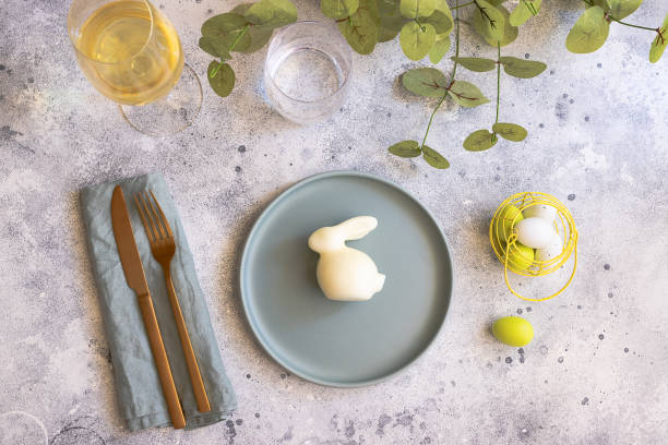 istock Happy Easter concept. Easter decoration : Bunny, Painted Egg and mint green plate with  gold cutlery. Scandinavian style  background with copy space 1135478053