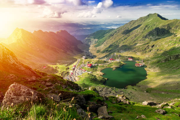 Above view of lake Balea in Fagaras mountains on a bright sunny day Transfagarasan Balea glacier lake. Above view of lake Balea in Fagaras mountains on a bright sunny day balea lake romania stock pictures, royalty-free photos & images