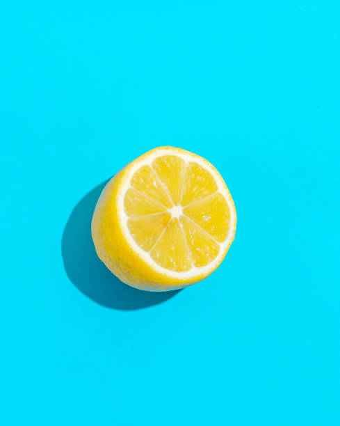 istock Top view of fresh lemon isolated on blue background. Fruit minimal concept. 1135478158