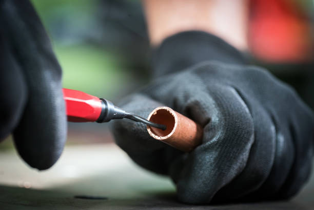 istock Work in the workshop cleaning and cutting the copper water pipe 1135478329