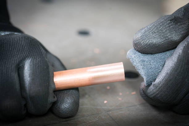 istock Work in the workshop cleaning and cutting the copper water pipe 1135479151