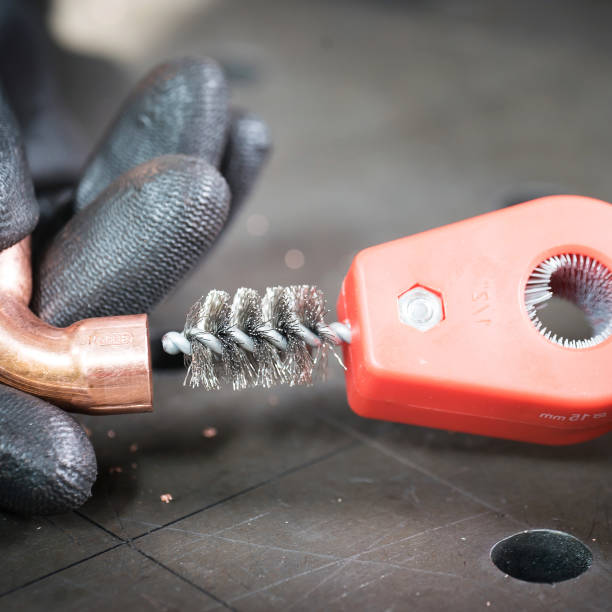 istock Work in the workshop cleaning and cutting the copper water pipe 1135479341