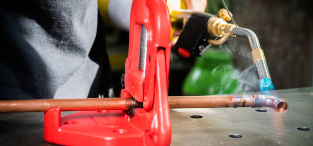 istock In the workshop, connecting copper pipes with a burner 1135479398