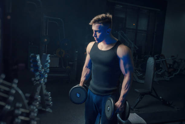 istock the sporty boy trains with dumbbells 1135479507