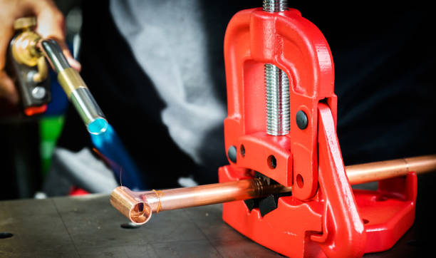 istock In the workshop, connecting copper pipes with a burner 1135480560