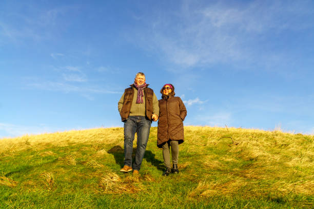 istock Senior couple walking on countryside path in winter 1135482166