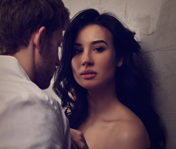 istock Unhappy serious woman hugging her husband and with deep thinking eyes looking in camera. Closeup toned art portrait. 1135482414