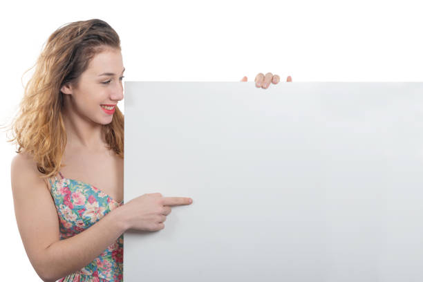 happy smiling young woman showing an empty blank signboard with copyspace