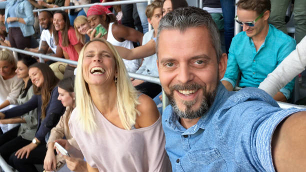 istock Couple taking selfie in stadium 1135483358
