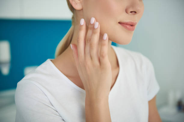istock Young lady gently touching her face with perfect smooth skin 1135483863