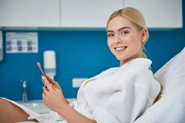 istock Charming young woman using cellphone in beauty salon 1135483949