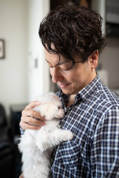 istock Man embracing puppy 1135484205