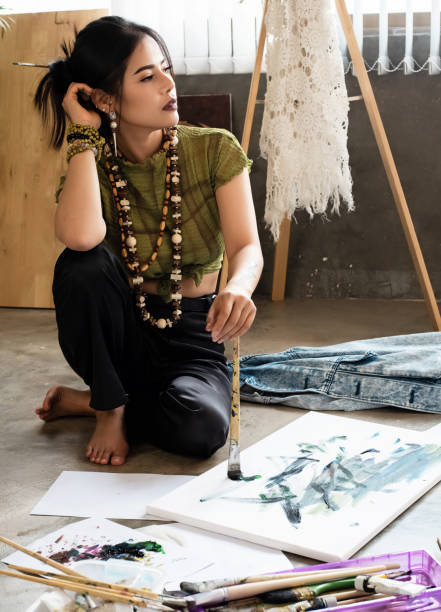 istock Tha young artist doing art painting at her art work studio,looking outside window for create imagination,at painting studio 1135484417