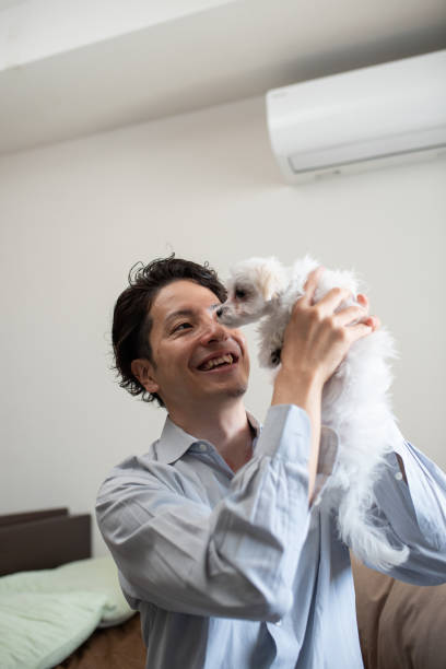 istock Man lifting puppy and talking 1135484528